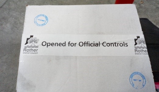 The resealed box of fish that has the Rother District Council logo on it and reads 'Opened for Official Controls'