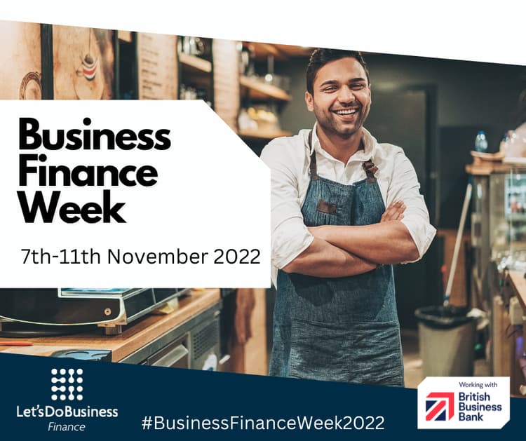Business Finance Week. 7th-11th November 2022. A picture of a man smiling wearing an apron standing in a cafe with his arms folded