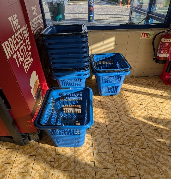 Picture shows supermarket shopping baskets stacked to a reasonable height.