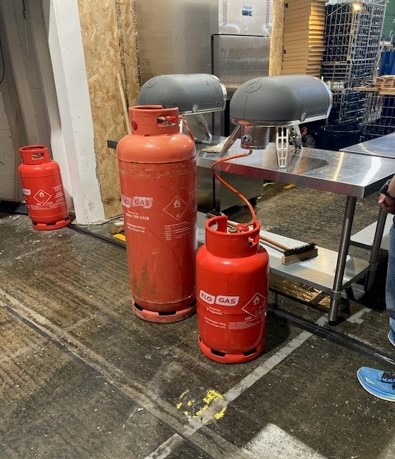 Gas cylinders powering pizza ovens