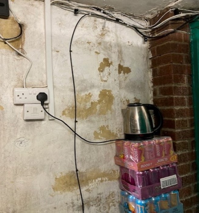 A kettle balanced on shop stock